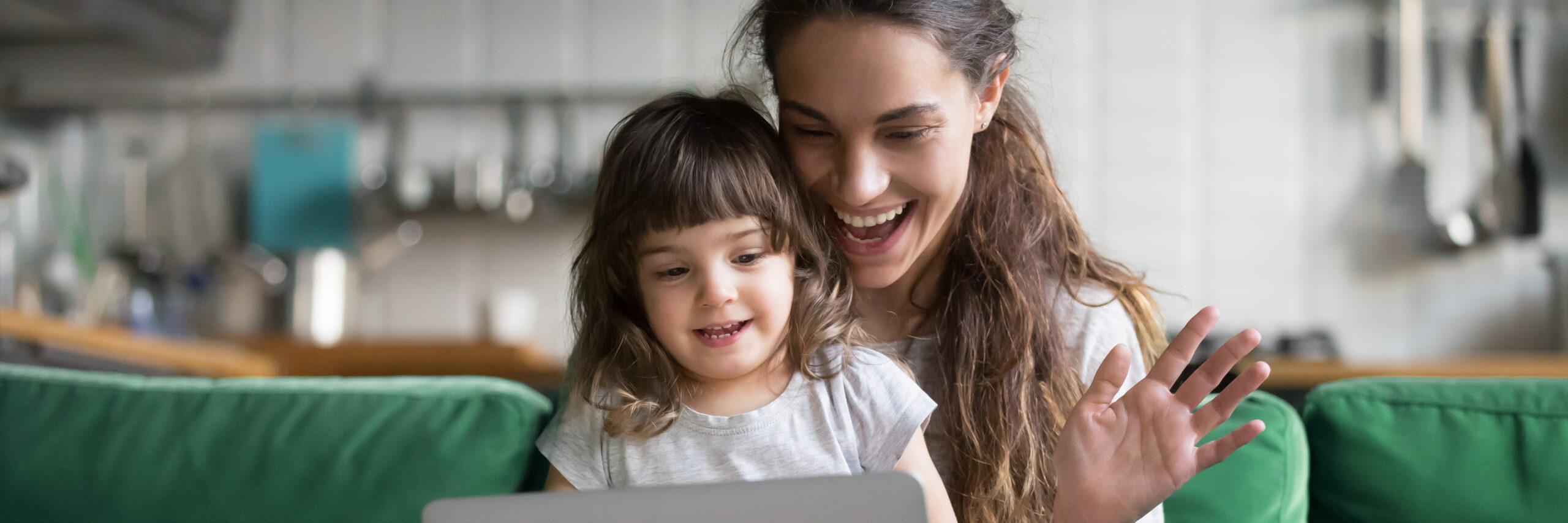 Woman and young girl using computer to make video call