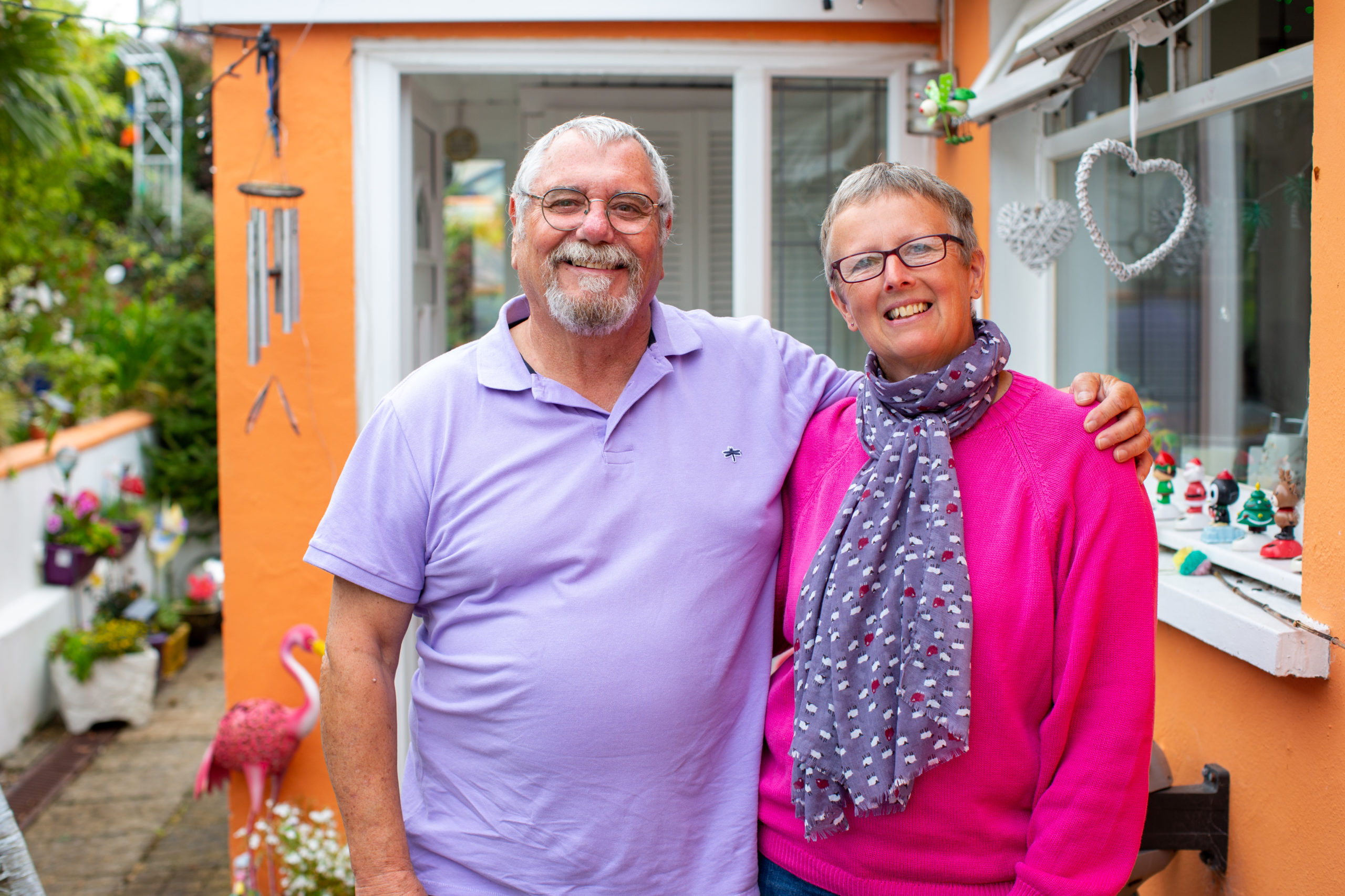 happy couple standing by front door