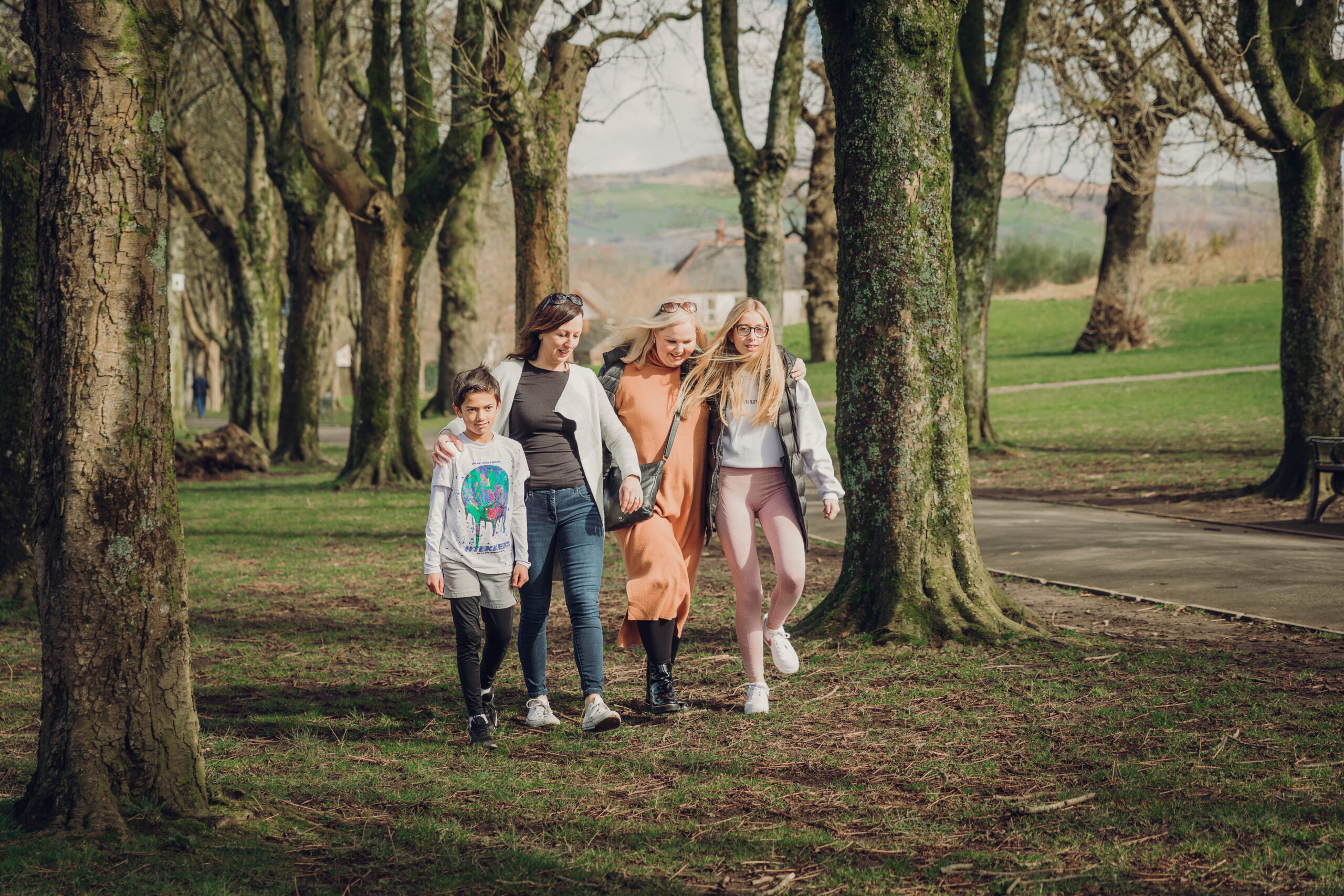 two-mums-walking-in-woods-with-children